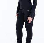 Person wearing black leggings and white sneakers on a white background