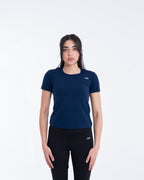 Woman wearing a navy blue t-shirt and black pants on a white background