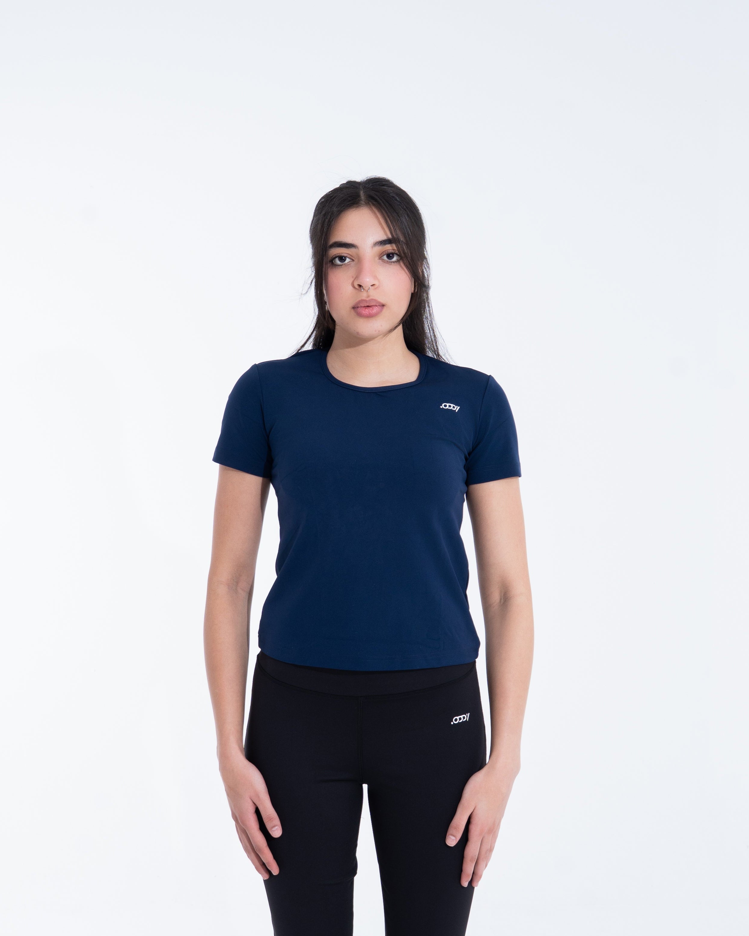 Woman wearing a navy blue t-shirt and black pants on a white background