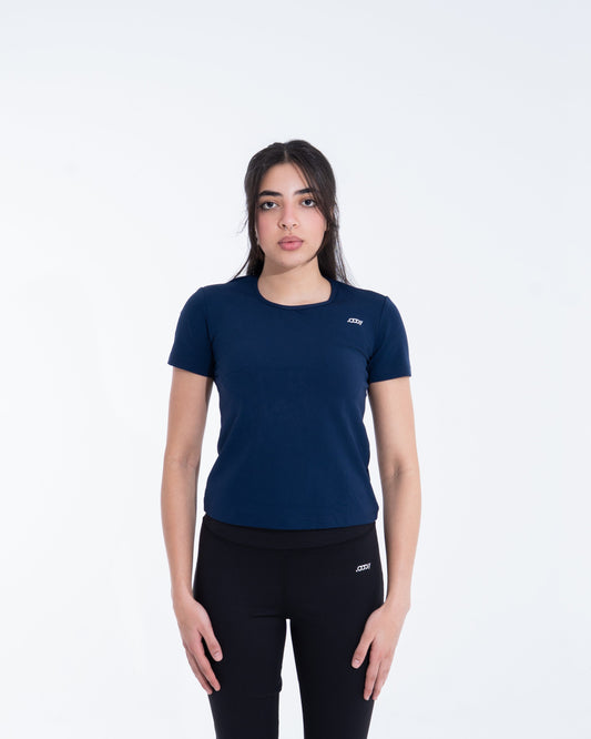 Woman wearing a navy blue t-shirt and black pants on a white background